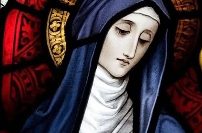 Santos cerveceros: los patrones que protegen la cerveza desde la Edad Media 11 Vitral de Santa Brigida de Irlanda con manto azul, patrona asociada a la tradicion del ale en la historia cervecera irlandesa medieval