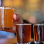 Copas de cerveza artesanal servidas en un bar, mercado cervecero de África subsahariana