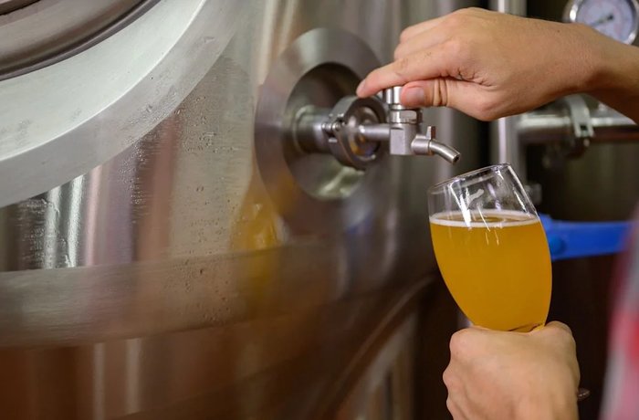 Cervecero revisando la calidad de la cerveza en una fábrica, como la de Velké Březno de donde Heineken saca la producción de Březňák